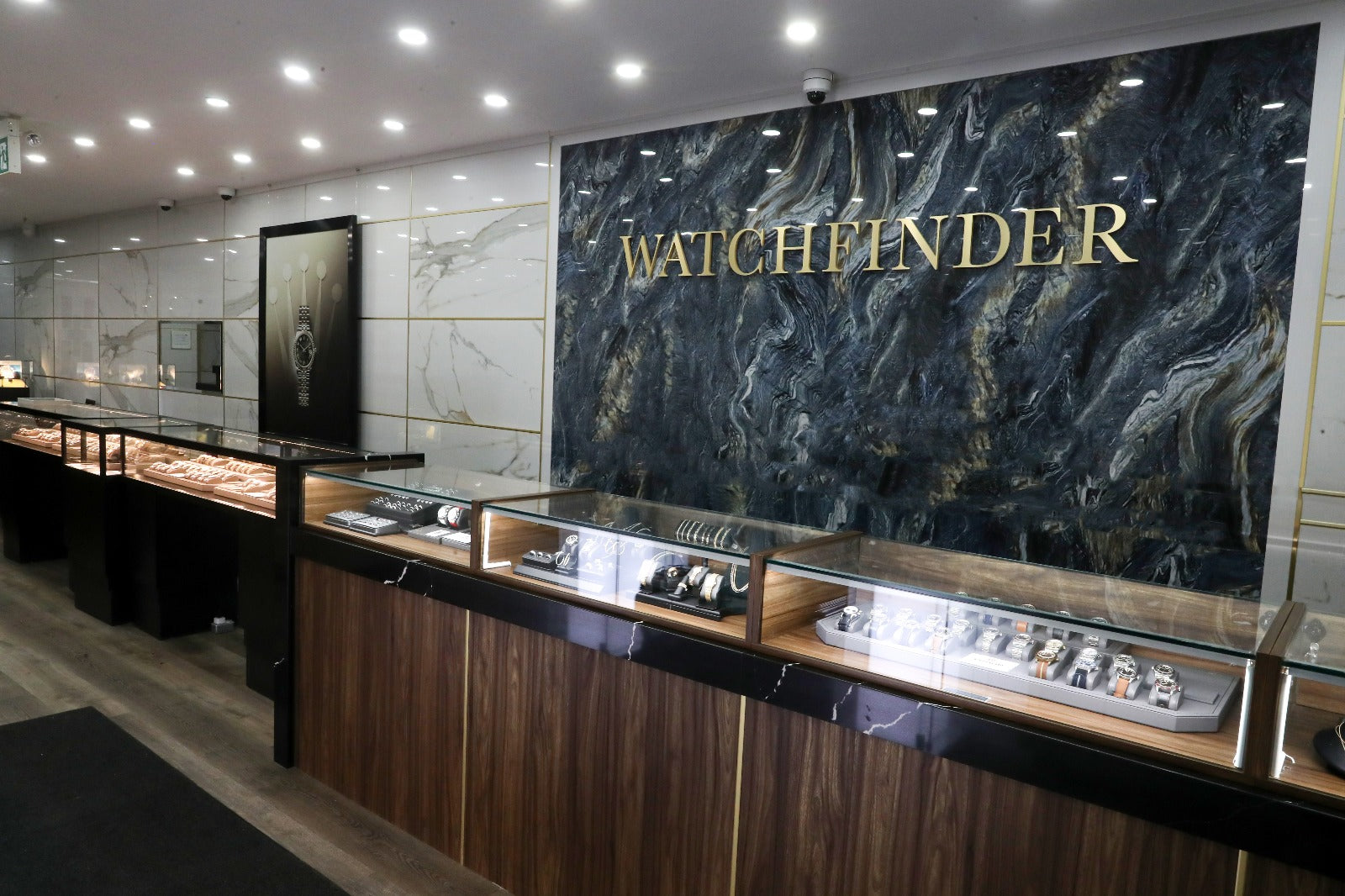 Watchfinder Canada Toronto showroom with watch display cases and the Watchfinder sign
